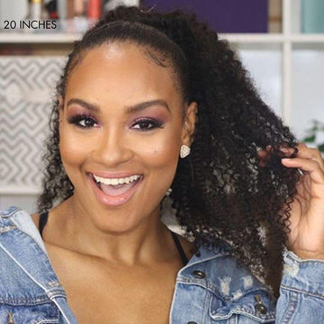Black woman wearing 20 inch afro curly ponytail wig and smiling happily