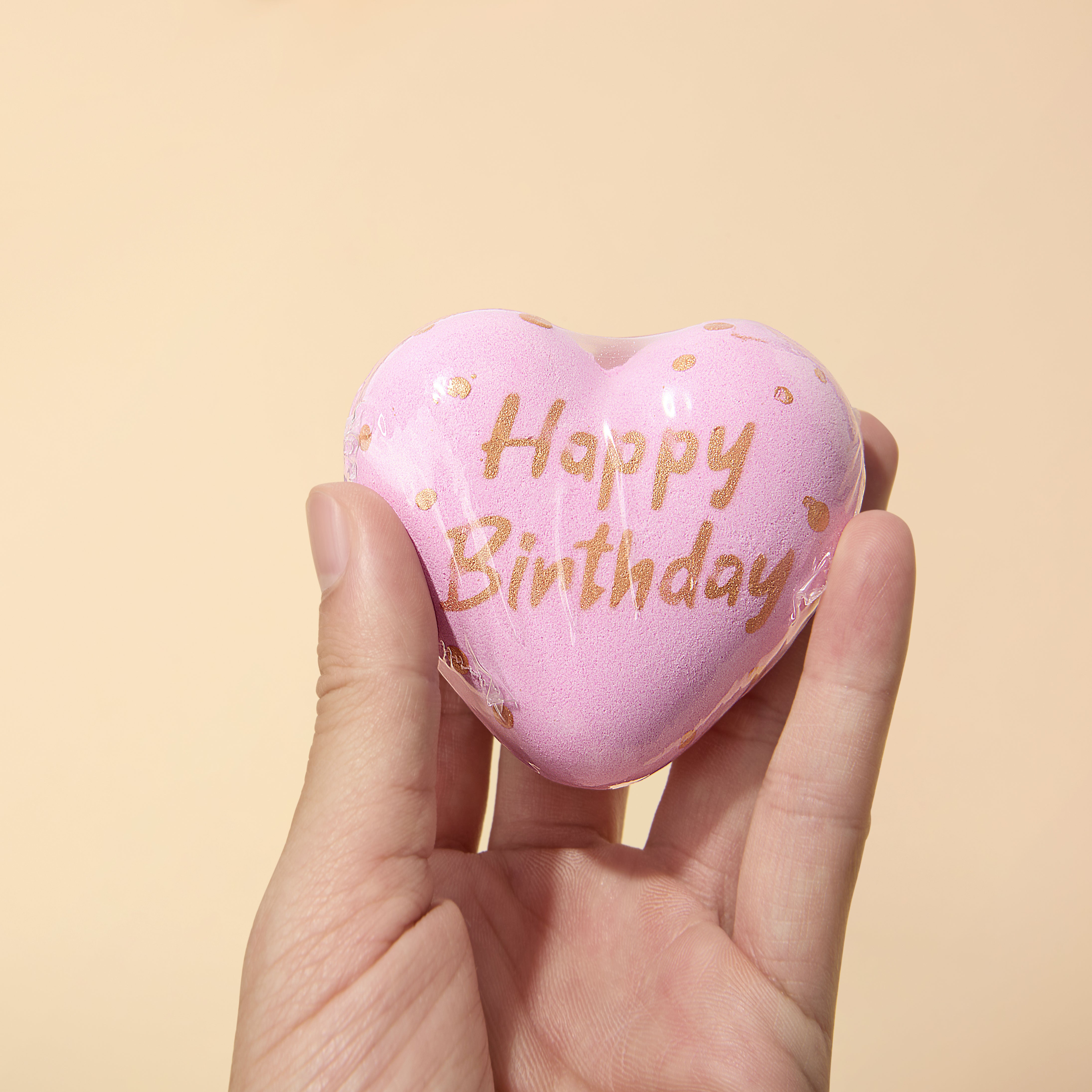Luvme Hair VIP birthday gift set featuring golden-themed bath balls arranged in a decorative display.