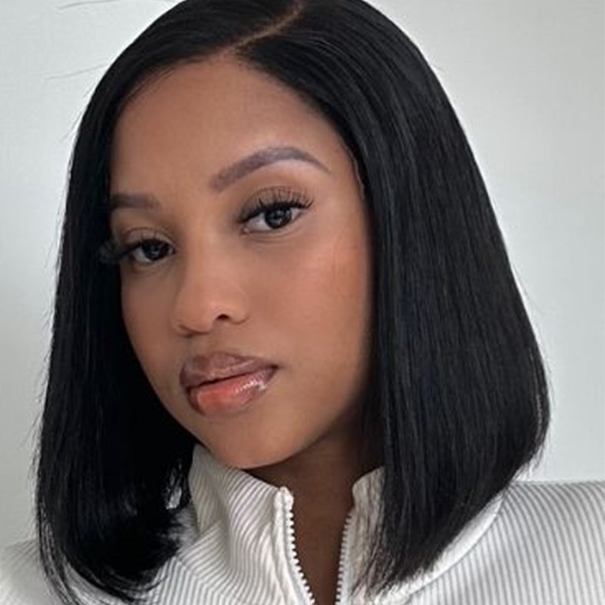 Luvme 12-inch deep wave and blunt cut bob HD lace glueless wigs, minimalist style, natural hair appearance in image.