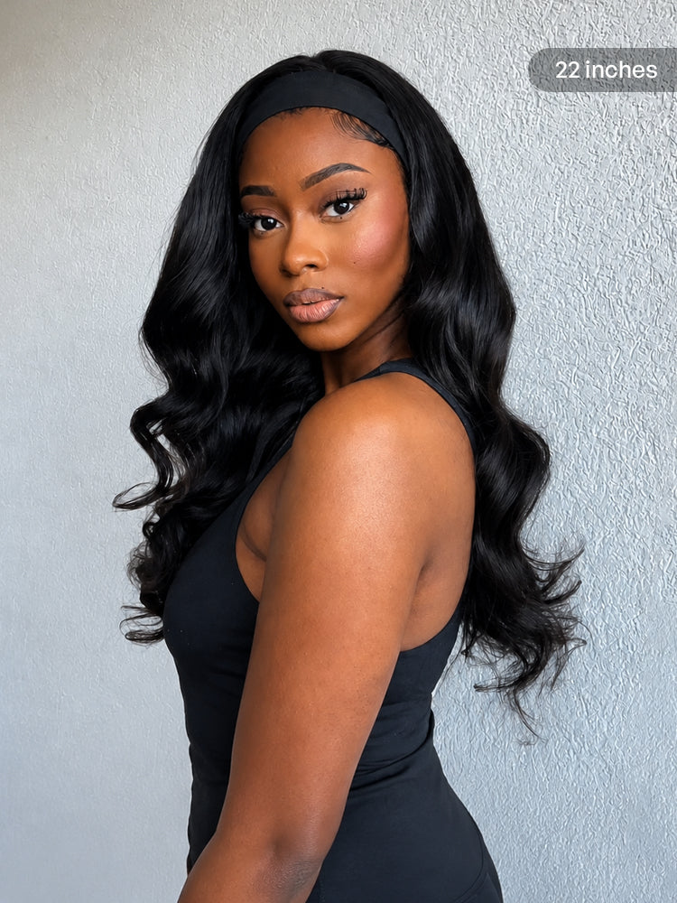 Luvme natural black body wave no lace glueless long headband wig made of 100% human hair, styled with a headband.