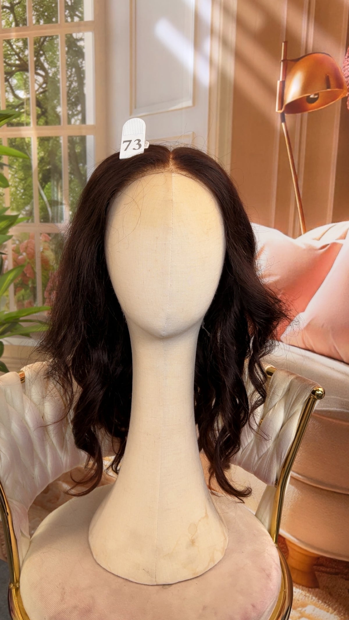 Luvme Hair outlet wig with dark brown wavy hair styled with loose curls, showcasing natural volume and shine.