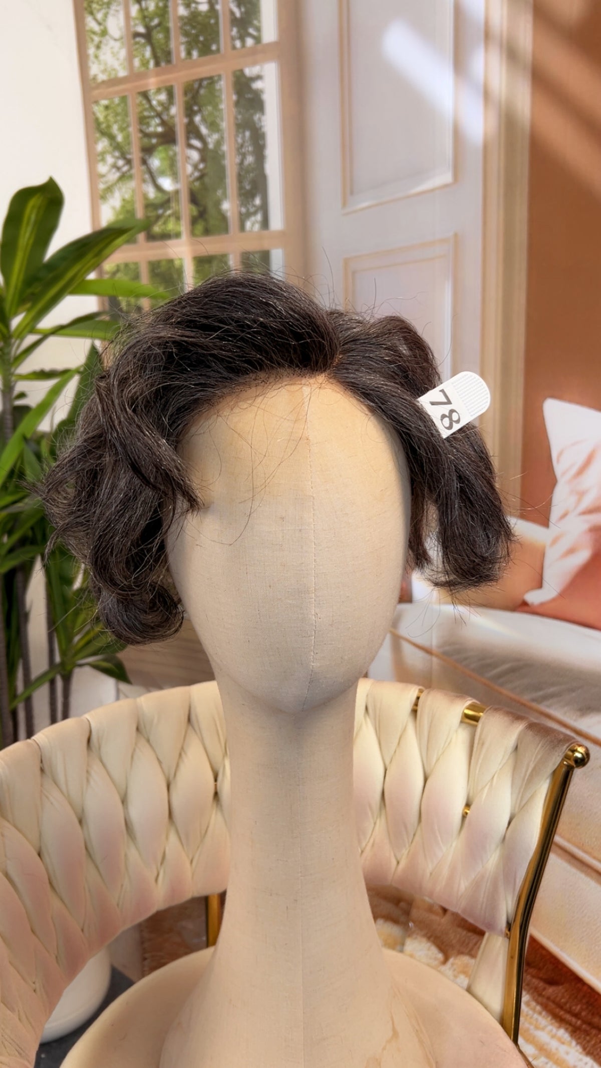 Luvme Hair live outlet wig displayed on a mannequin head, showcasing its style, texture, and natural hair color.
