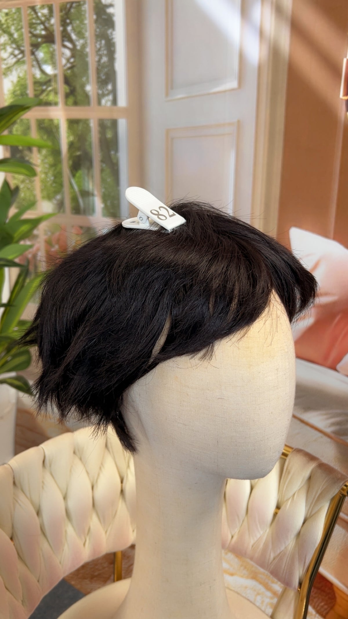 Luvme Hair live outlet wig showcasing a natural black, wavy lace front wig with adjustable straps on a mannequin head.