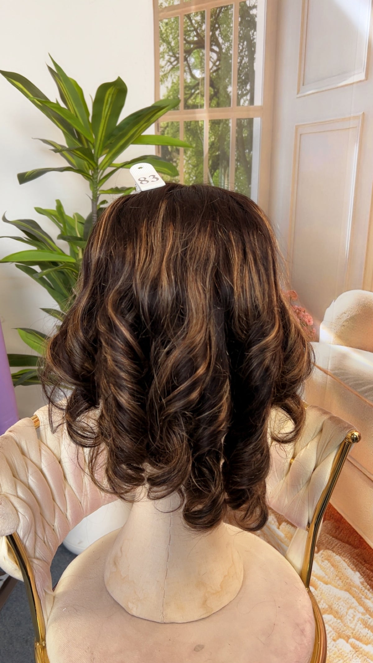 Luvme Hair outlet wig displayed on a mannequin head, showcasing the style and texture of the synthetic or human hair wig.