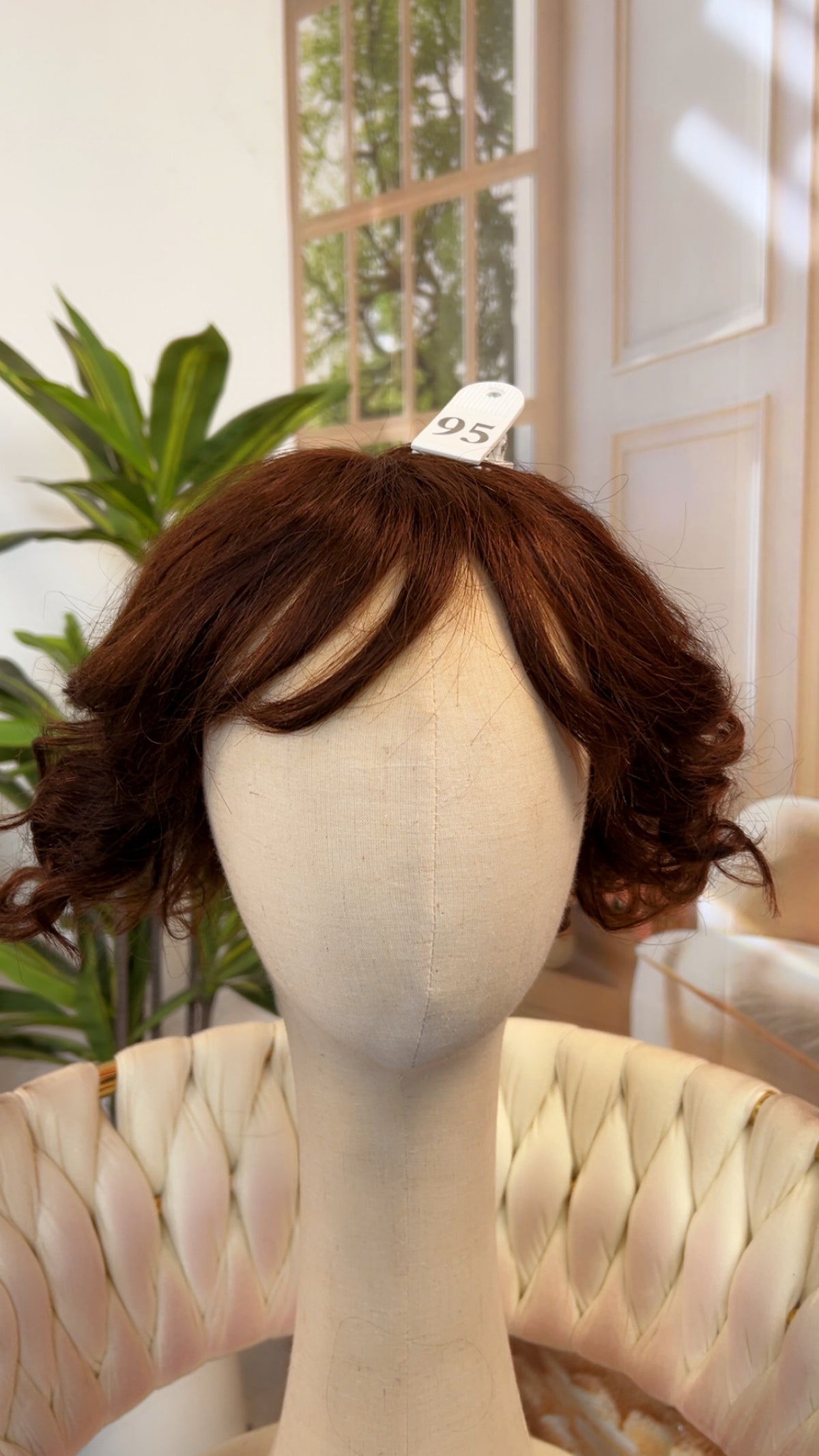 Luvme Hair live outlet wig with curly black hair styled in a shoulder-length cut, showcasing the textured, voluminous curls.