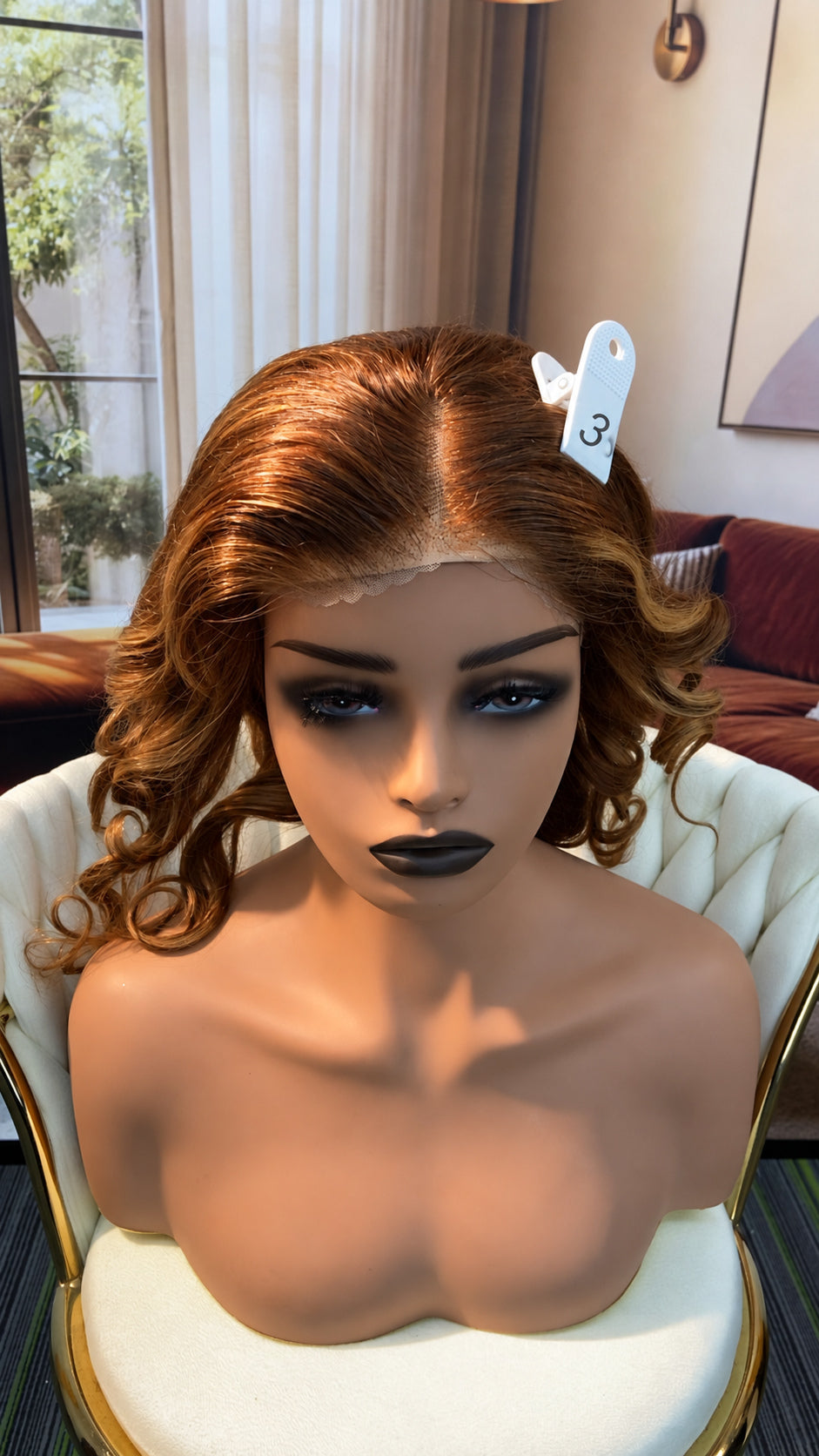 Luvme Hair live outlet wig displayed on a mannequin head, showcasing a natural-looking curly hairstyle in various shades.
