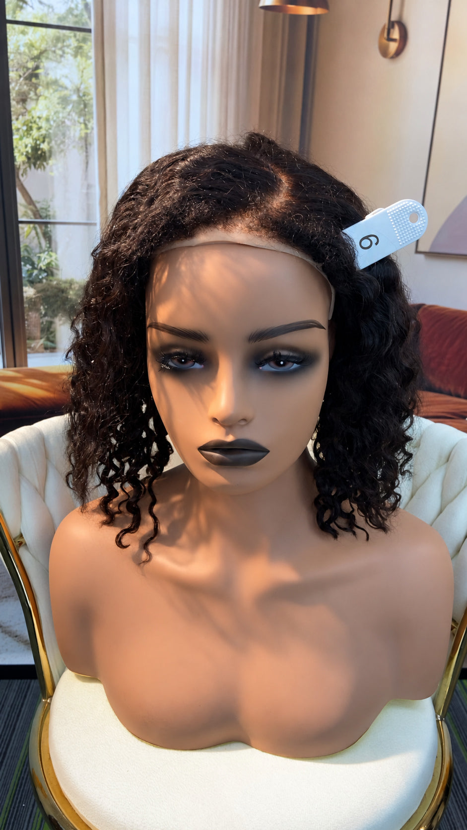 Luvme Hair outlet wig displayed in natural brown, styled with loose waves, on a mannequin head.
