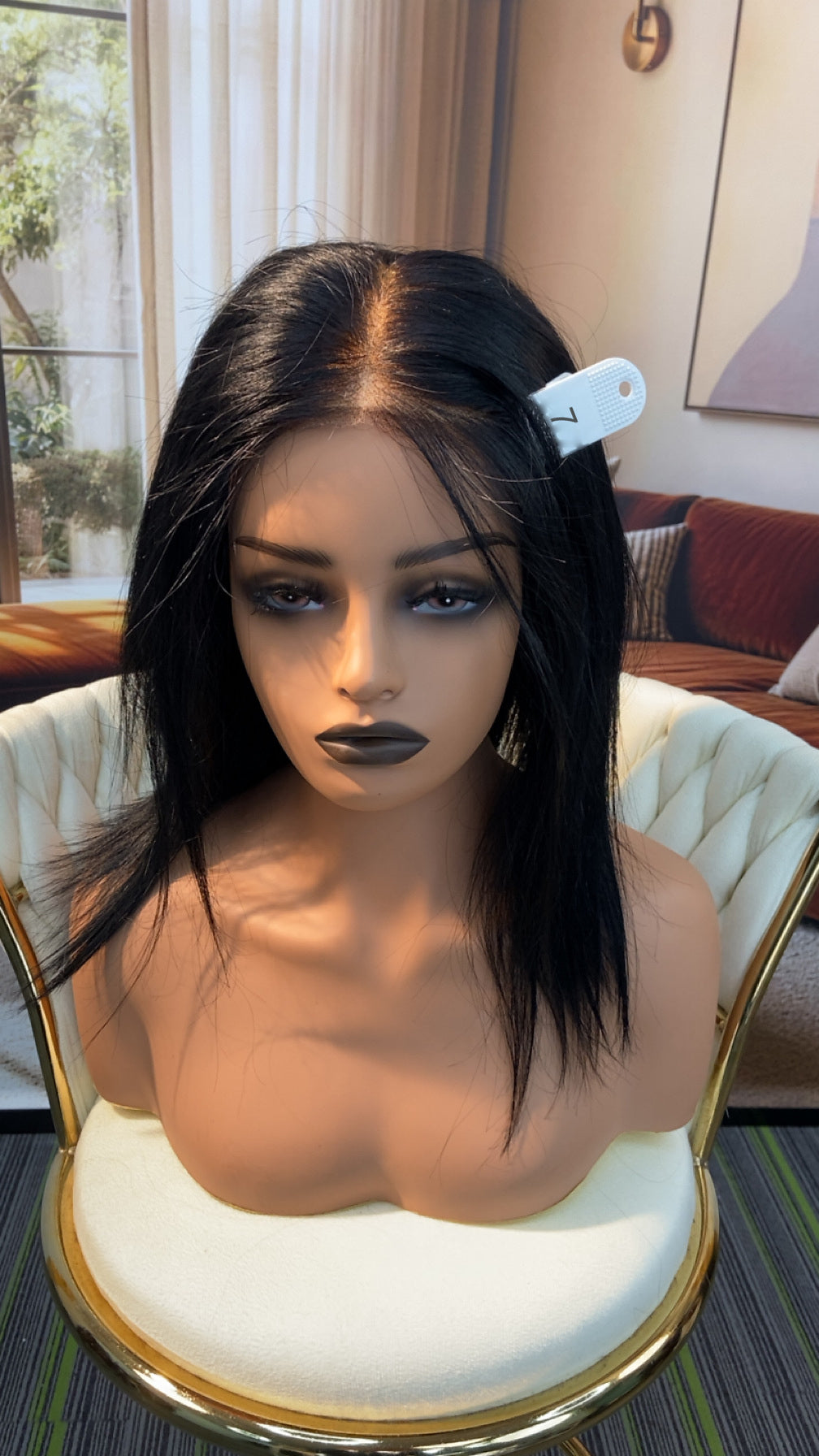 Luvme Hair outlet wig on a mannequin head, showcasing a stylish, natural-looking wig with layered brown hair and soft waves.