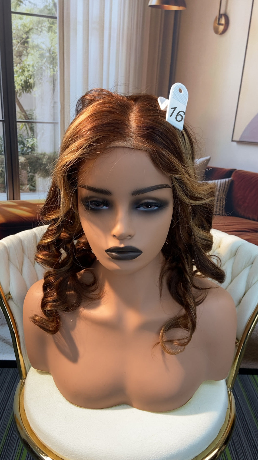 Luvme Hair outlet wig with natural black straight long hair, styled with a center part, displayed on a mannequin head.