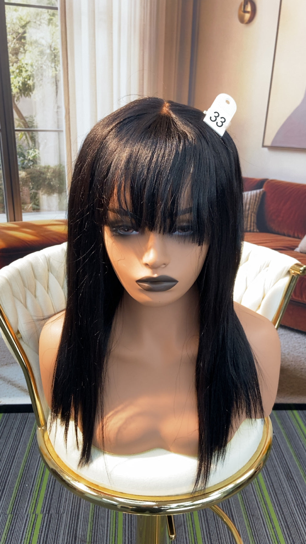 Luvme Hair live outlet wig on display, showcasing a stylish, full lace wig with natural black color and intricate lace detailing.