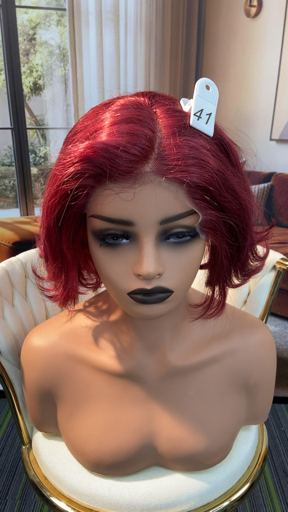 Luvme Hair live outlet wig displayed on a mannequin, showcasing its style and texture in natural light.