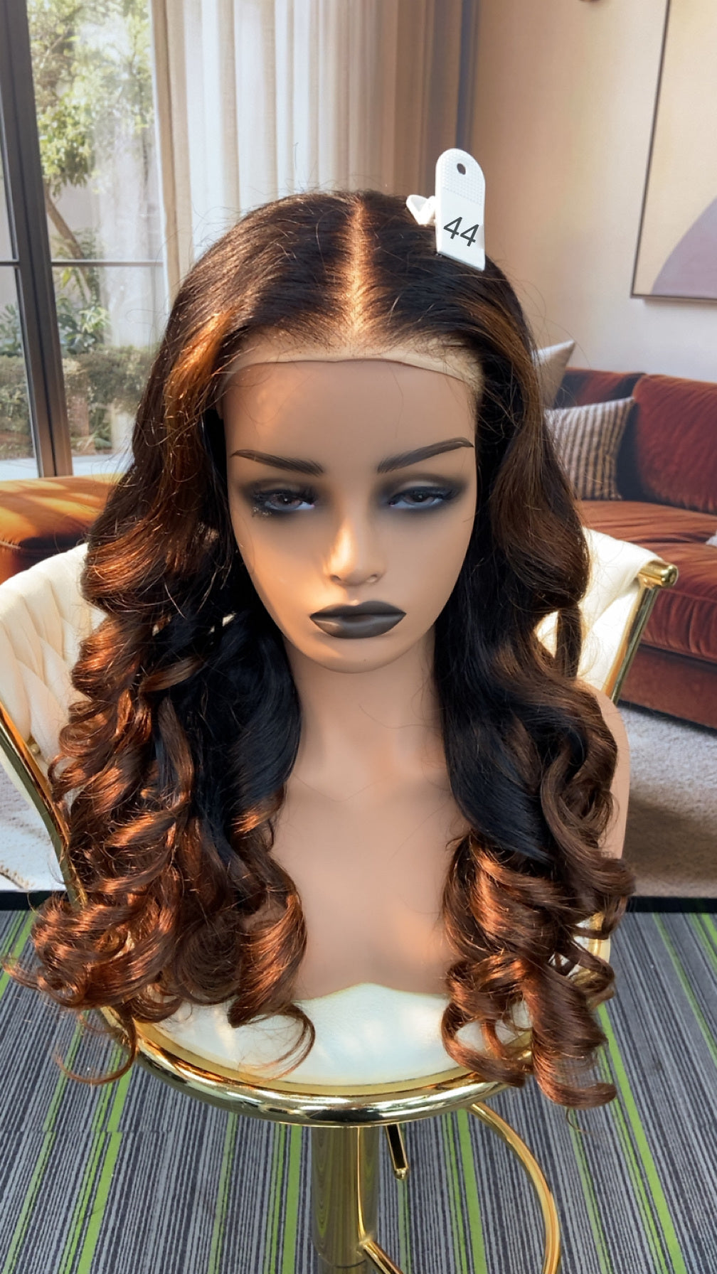 Luvme Hair live outlet wig displayed on a mannequin head, showcasing a natural-looking, straight hairstyle with dark color.