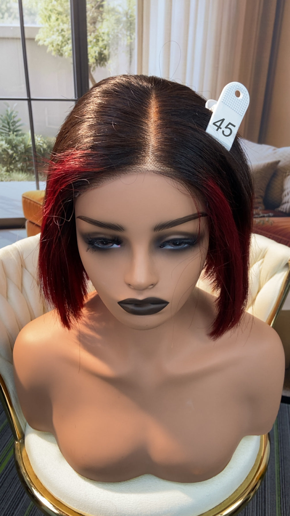 Luvme Hair live outlet wig in natural black, styled with loose curls, displayed on a mannequin head for sale at 50% off.