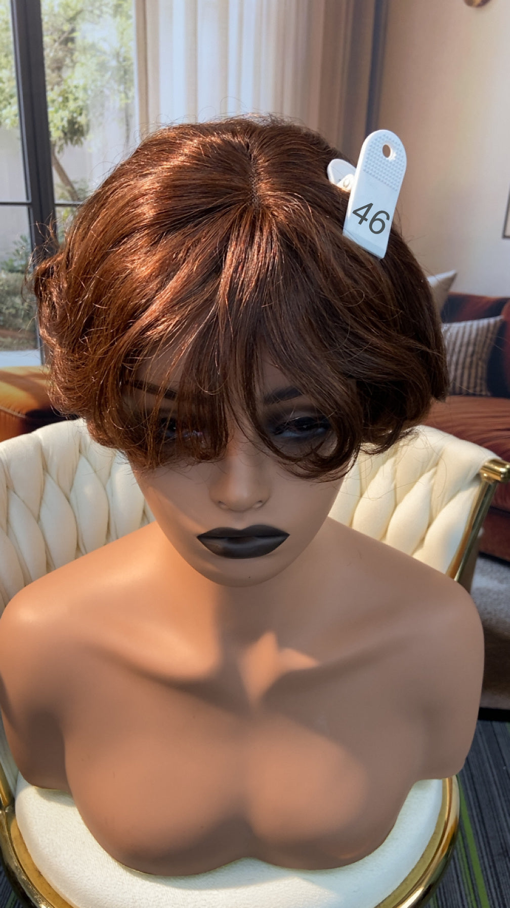 Luvme Hair live outlet wig in natural brunette, shoulder-length with layered style, displayed on a mannequin head.