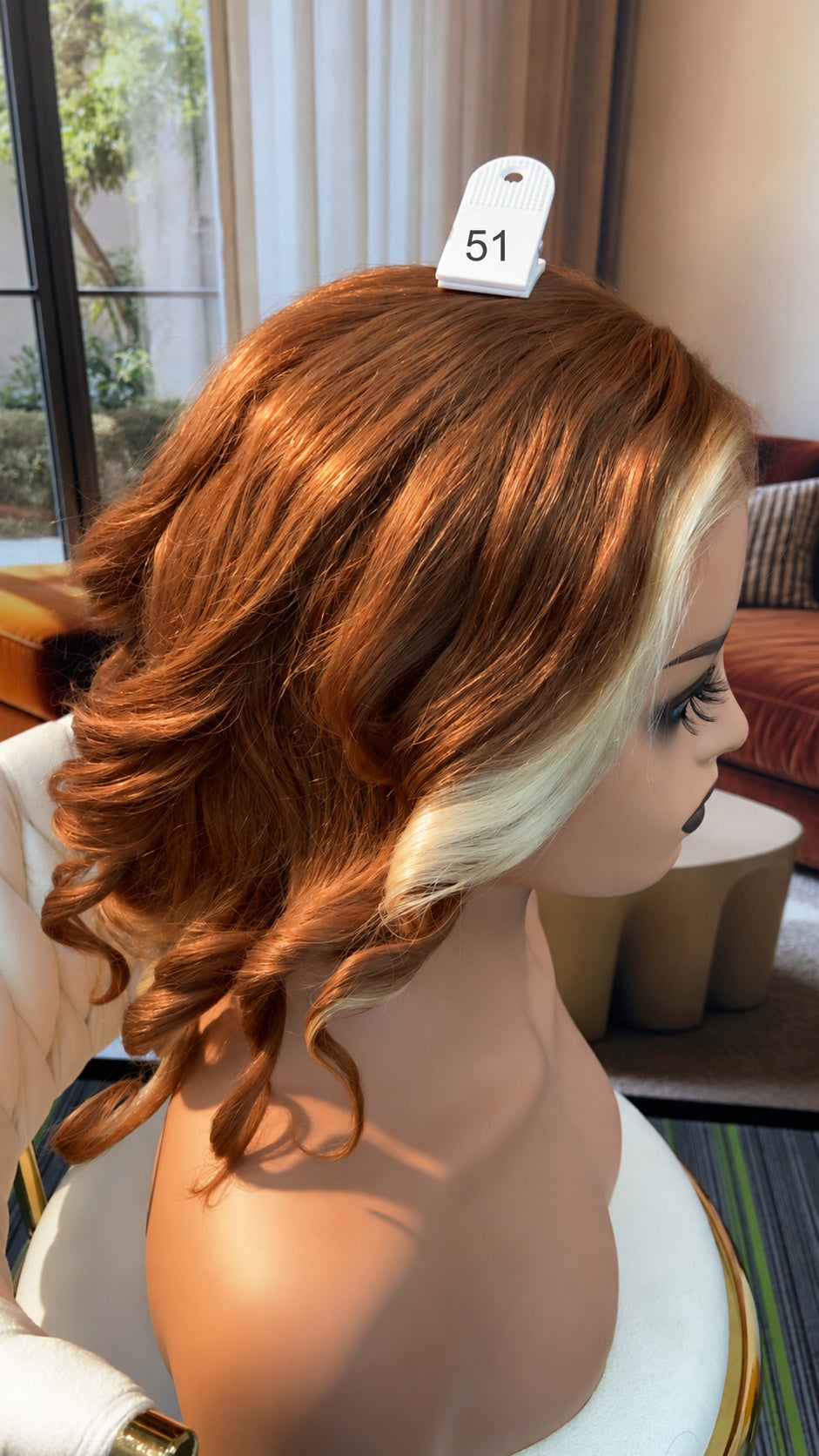 Luvme Hair outlet wig featuring long, curly black hair on a mannequin head, showcasing a stylish synthetic wig.