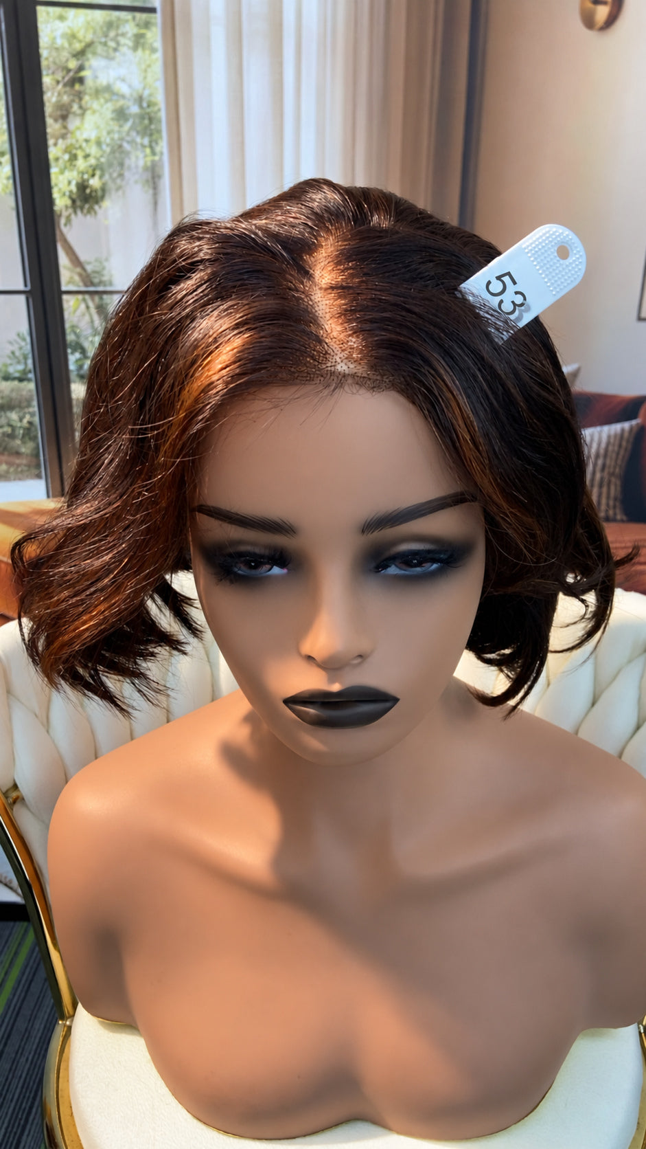 Luvme Hair live outlet wig in natural black with layered style, showcasing soft, wavy hair texture and full cap construction.
