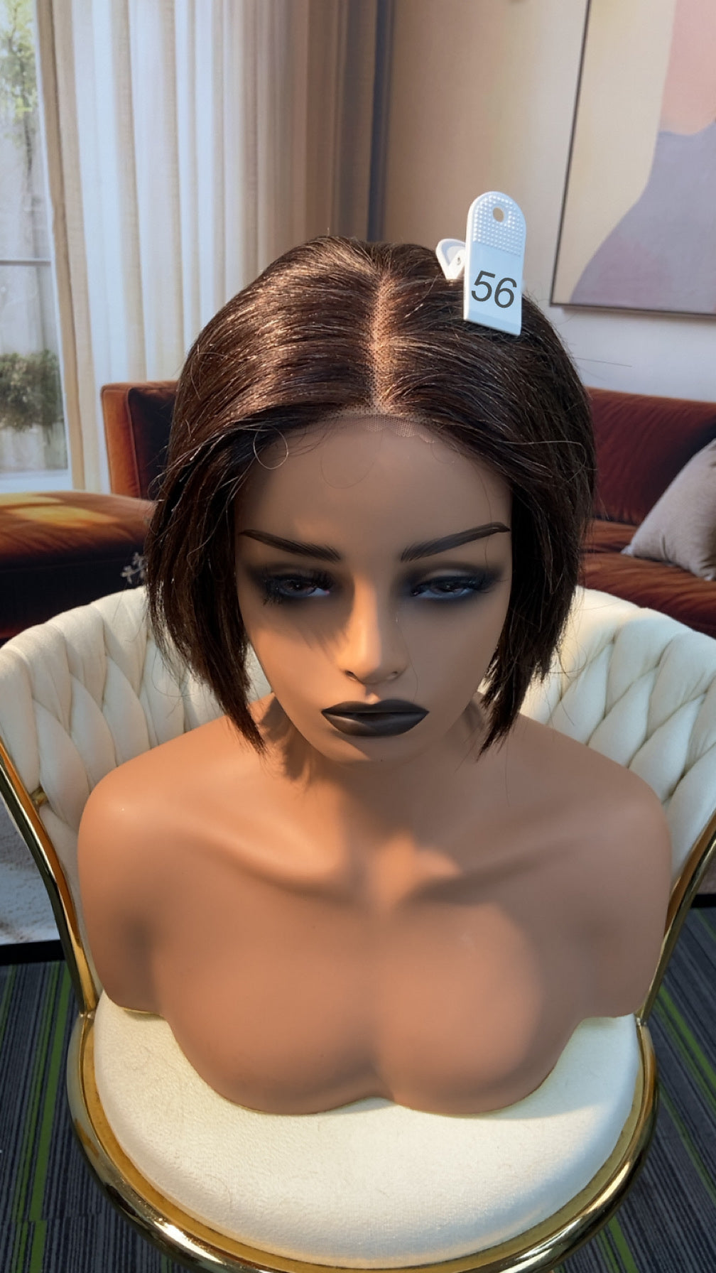 Luvme Hair outlet wig with 50% off, featuring a natural-looking curly style, styled on a mannequin head.
