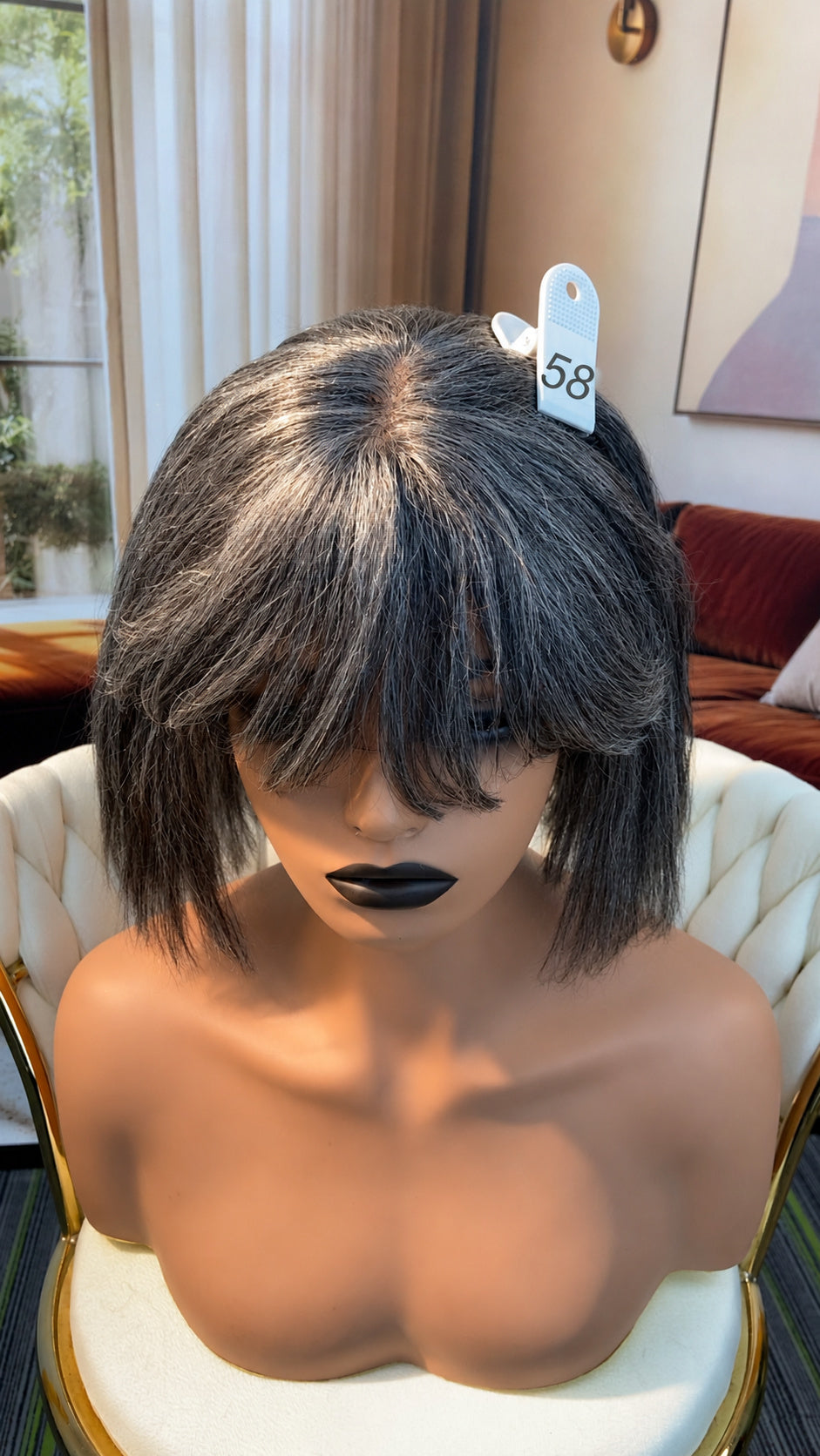 Luvme Hair live outlet wig displayed on a mannequin, showcasing a natural hairline and styled in loose waves.