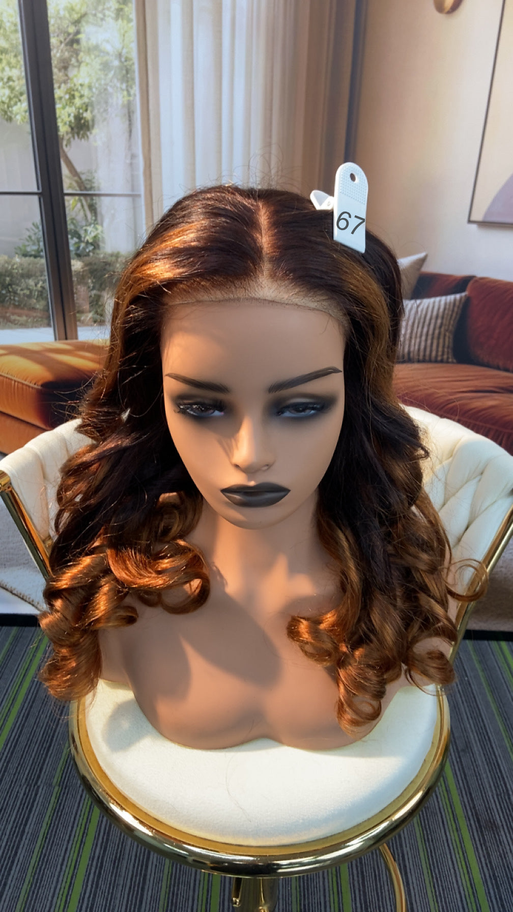 Luvme Hair live outlet wig displayed on a mannequin head, showcasing the wig's style and texture in natural lighting.