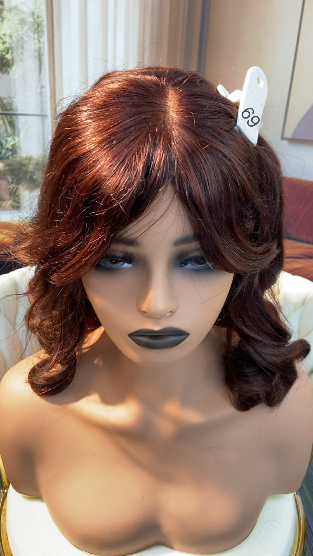 Luvme Hair live outlet wig with 50% off, featuring a natural style and full head of curly, dark brown hair.