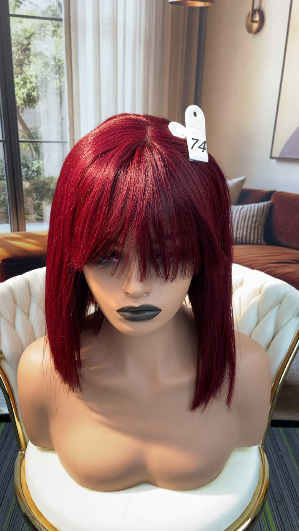 Luvme Hair live outlet wig displayed on a mannequin head, showcasing a natural hairstyle with wavy, medium-length hair.