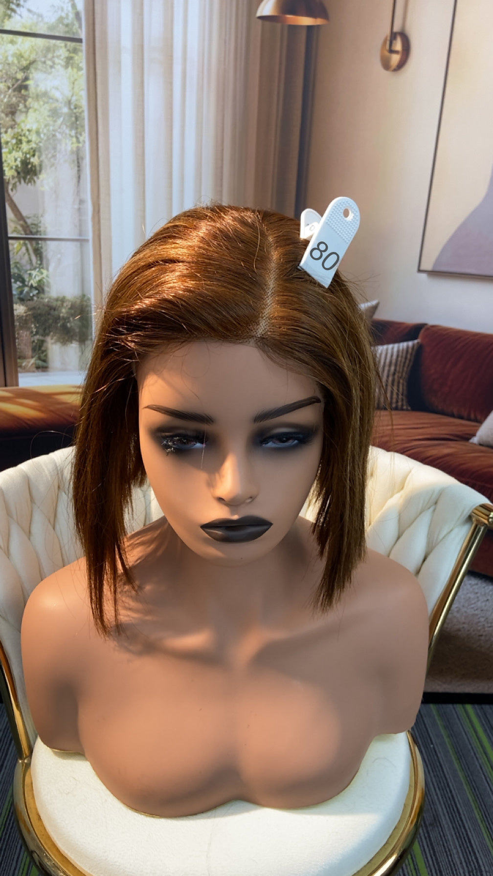Luvme Hair live outlet wig displayed on a mannequin head, showcasing its style and texture in natural light.