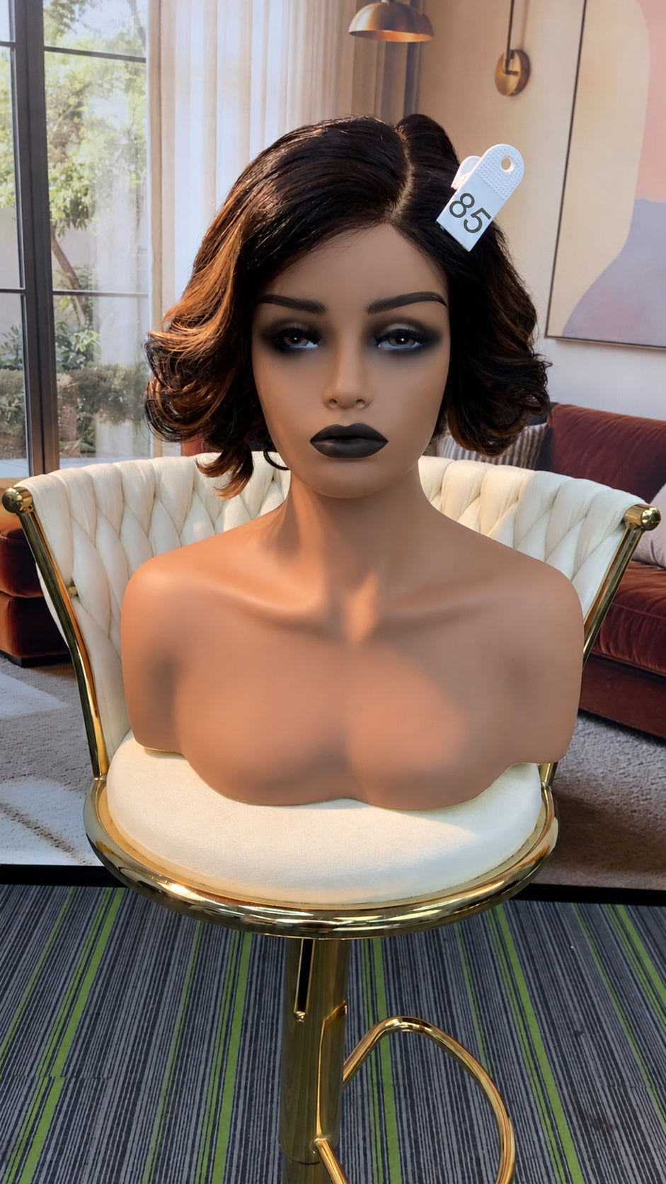Luvme Hair live outlet wig display with different styles in natural hair textures and colors, promotional offer sign visible.