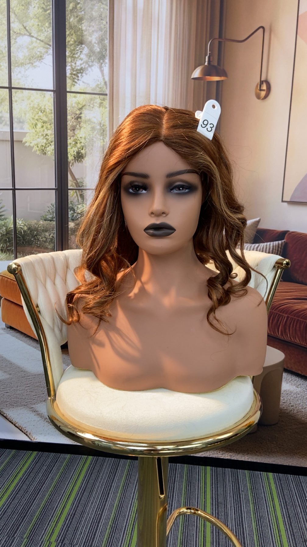 Luvme Hair live outlet wig displayed on a mannequin head, showcasing curly, blonde synthetic wig with natural hairline.