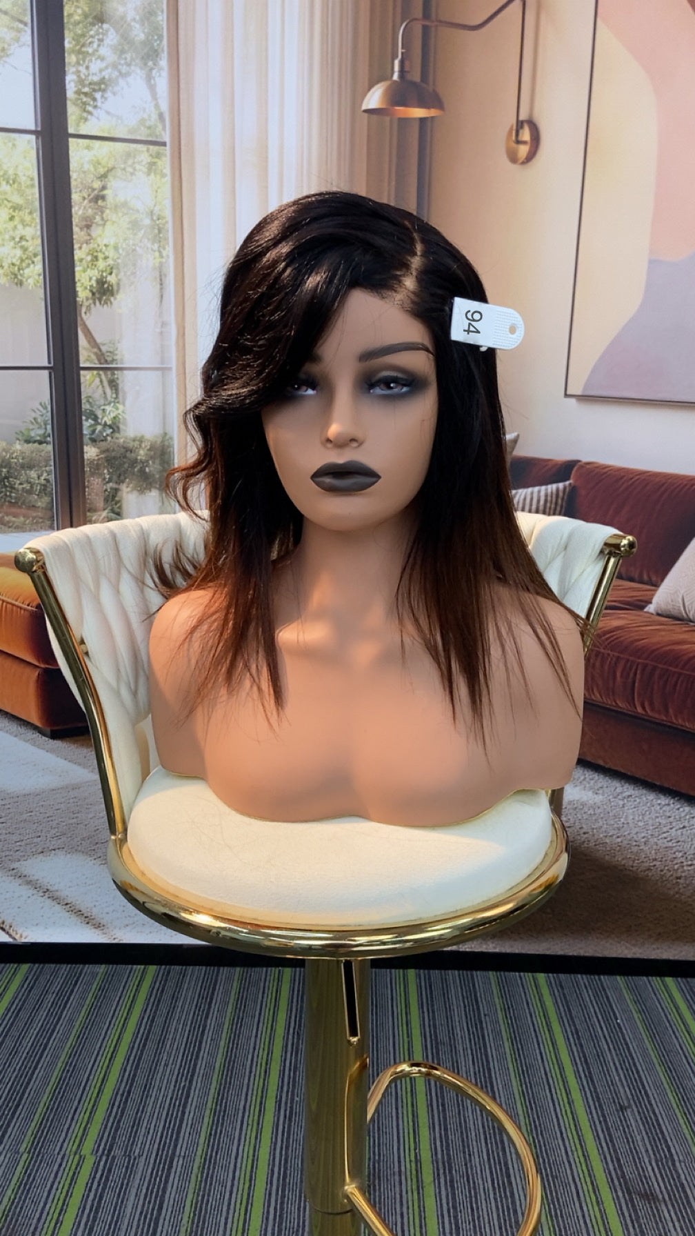 Luvme Hair live outlet wig displayed on a mannequin head with styled brown hair and natural waves, showcasing the product's texture and style.