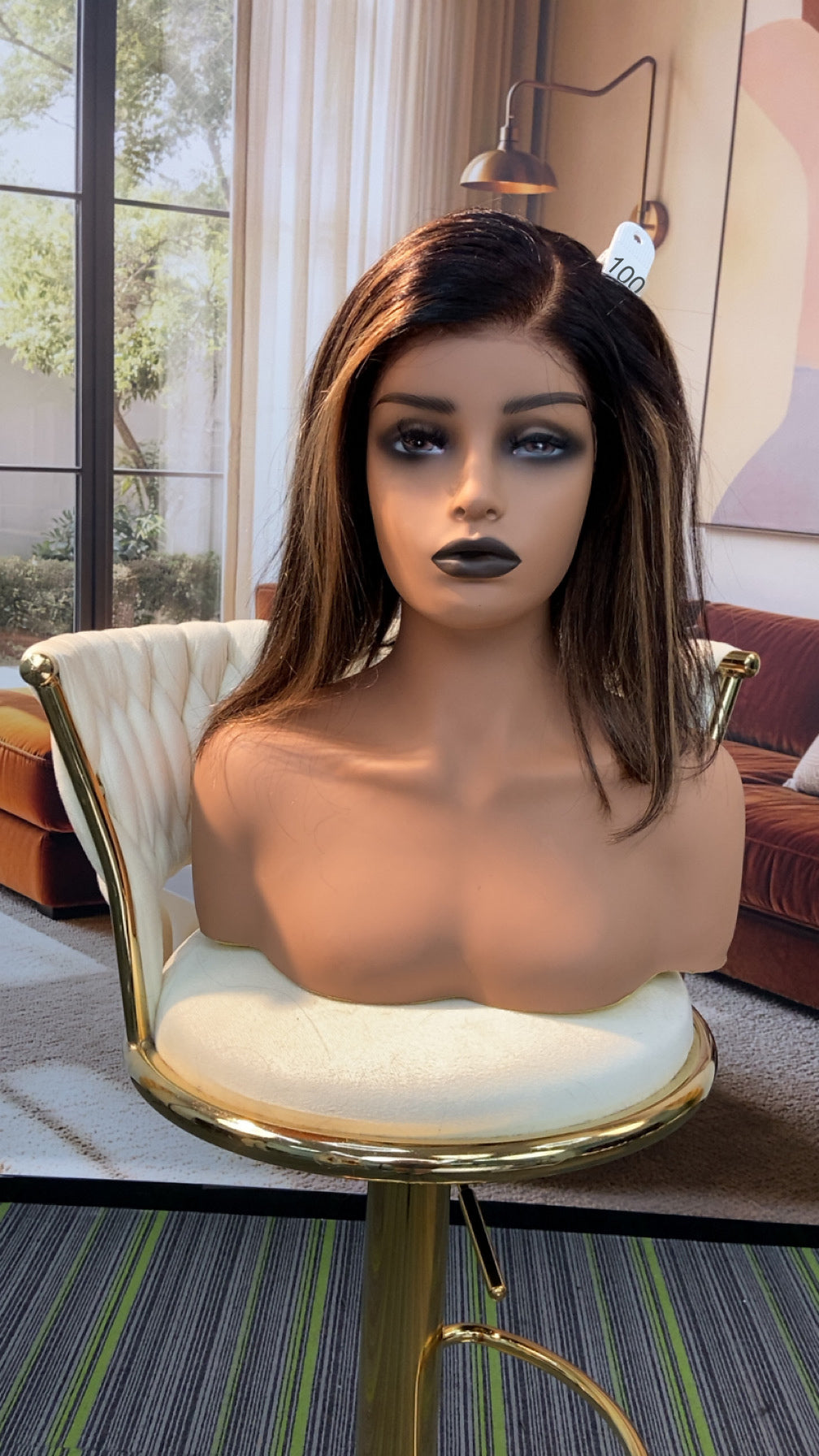 Luvme Hair outlet wig displayed on a mannequin with curly black style, highlighting the hair's texture and volume.