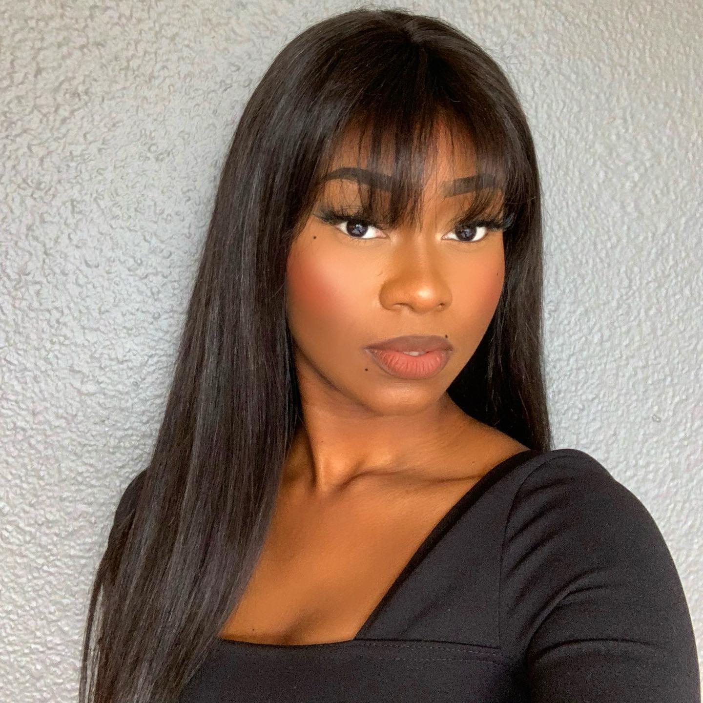 Luvme Throw On & Go Natural Black Straight No Lace Glueless Long Wig with Bangs, styled with sleek straight hair and full bangs.
