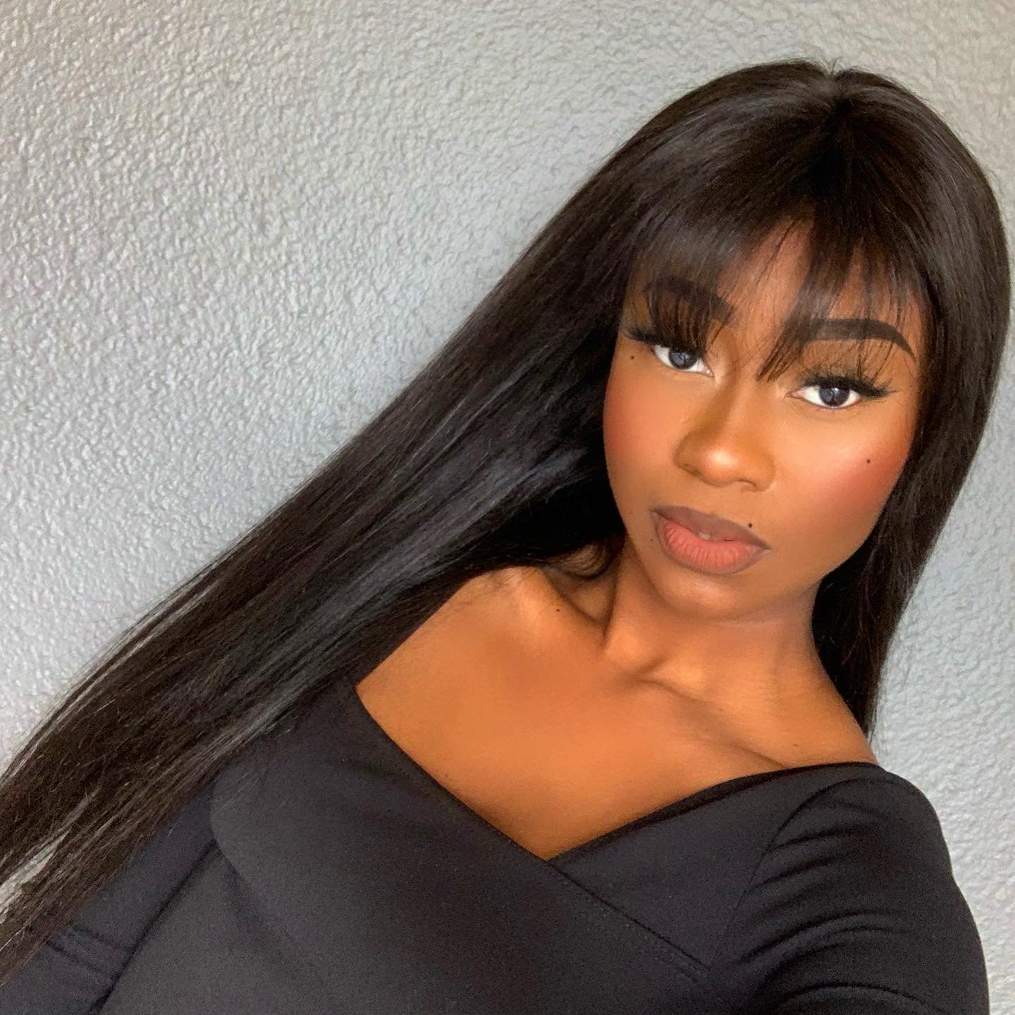 Luvme Throw On & Go natural black straight no lace glueless long wig with bangs, displayed on a mannequin head.