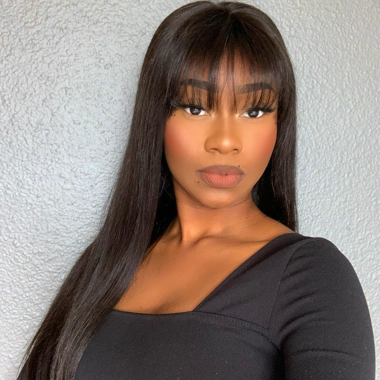 Luvme Throw On & Go natural black straight no lace glueless long wig with bangs, styled with sleek straight hair and full bangs.